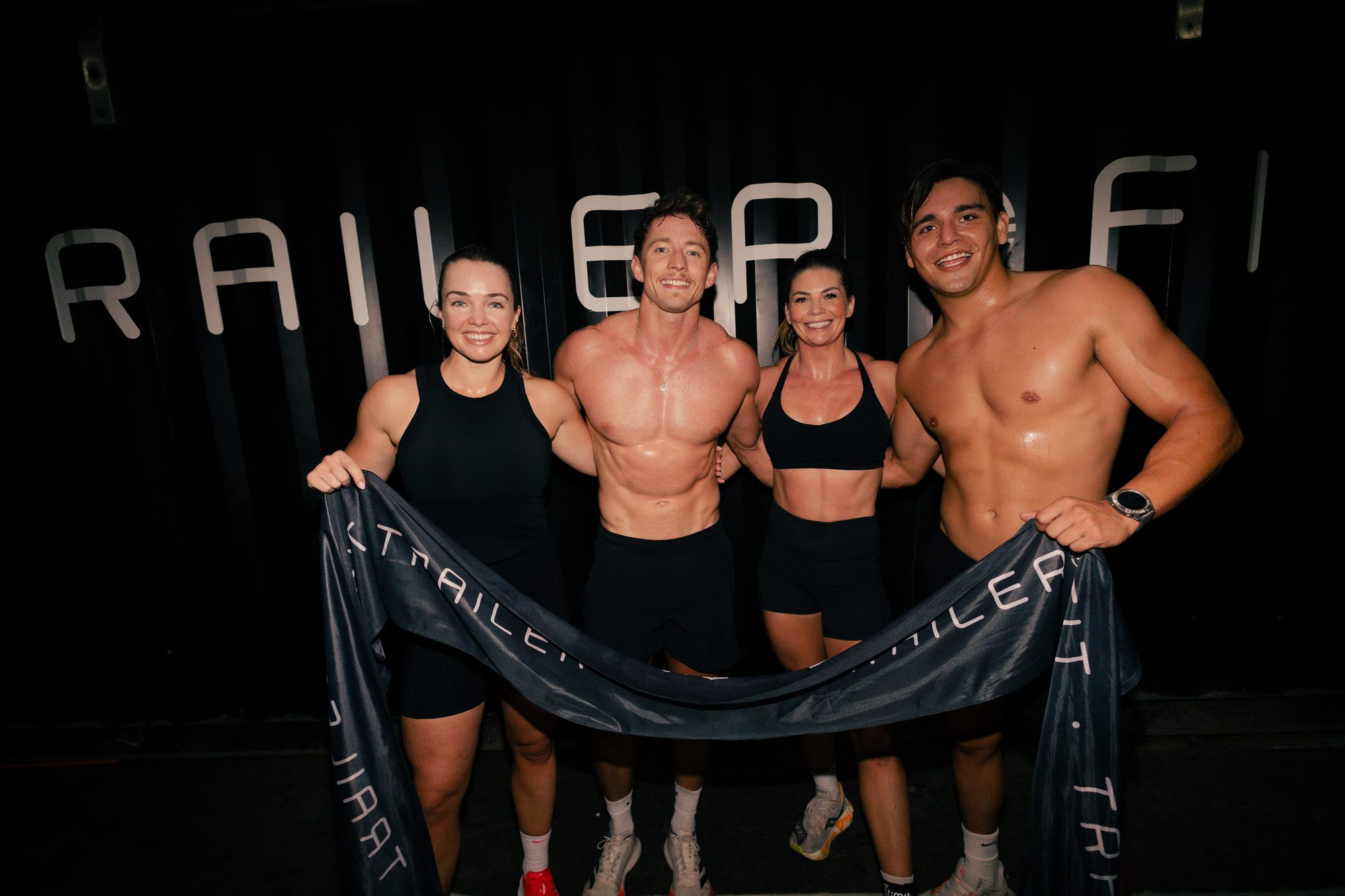 TrailerFit The Blueprint event, athletes with banner at the finish